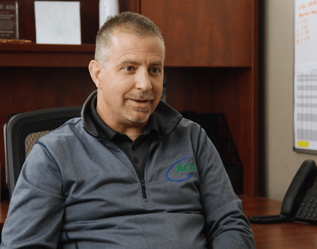 BCA employee discussing their success after receiving small business consulting services from Cogent Analytics