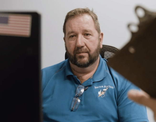 Doctor Electric employee learning from Cogent Analytics team